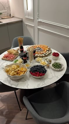 a white table topped with plates and bowls filled with food