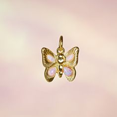 Butterfly Charm - Opal - Add a little magic with our adorable butterfly charm to add to any chain necklace or bracelet. Made with precious lab-grown opals & gold! Wildflower + Co. Jewelry ♥ Measurements: approx. 3/4" h  ♥ Materials: 12k polished gold plating,  & synthetic opals ♥ Designed by & exclusive to Wildflower + Co.  ♥ Lead, nickel & cadmium safe  ♥  Intended for use by adults only  ♥  Imported Cute Silver Jewelry With Butterfly Charm, Dainty Butterfly Charm Jewelry For Mother's Day, Mother's Day Butterfly Charm Pendant Necklace, Mother's Day Butterfly Pendant Necklace, Butterfly Charm Pendant Necklace As Gift, Butterfly Charm Jewelry For Birthday, Butterfly Charm Pendant Necklace For Gift, Cute Charm Necklaces As Gift, Dainty Charms Suitable For Gifts