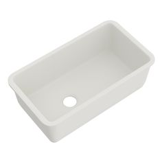 a white sink on a white background with a hole in the bottom left corner for water