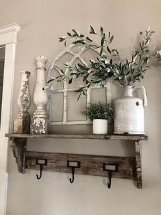 a shelf with some potted plants on top of it