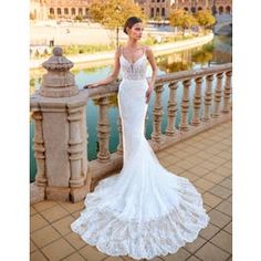 a woman in a wedding dress standing on a balcony