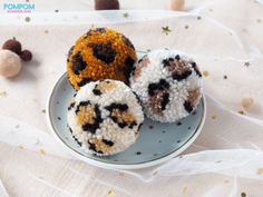 three different types of donuts on a plate with white and gold sprinkles