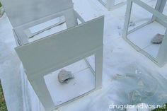 three cement blocks sitting on top of a white tarp covered ground with rocks in them