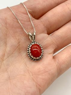 Red Coral Necklace set with a Natural Red Coral in a top grade & strong red color, at 10x8mm, 3 Cts, from Sardinia. Solid 925 Sterling Silver ☞ made to last.Matching Ring & Matching Earrings: Please ask meDetails: • Natural Red Coral sourced from Sardinia• Red Coral: 10x8mm, 3 Cts, diamond cut• Dimensions: Pendant Height 19.6mm, Width 9.2mm• Free Complimentary Chain• Solid 925 Sterling Silver ❀ Each Natural Gem is unique & will have Slight variations from the product pictures "no two Natural Sto Classic Red Oval Pendant Jewelry, Classic Red Oval Pendant Necklace, Elegant Red Jewelry With Cabochon, Elegant Red Cabochon Jewelry, Classic Red Round Jewelry, Red Cabochon Round Pendant Necklace, Classic Red Gemstone Jewelry, Formal Red Carnelian Jewelry, Classic Red Jewelry As A Gift