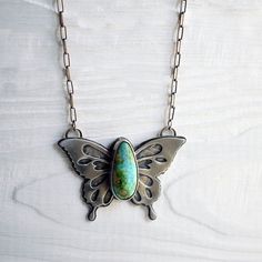 Beautifully handcrafted sterling silver butterfly pendant with a large, breathtaking high-grade Sonoran Gold turquoise stone.This heirloom quality piece is quite substantial & has some weight to it - with its layers & layers of sterling silver. This special piece has been intricately hand sawed, with pierce work throughout the butterfly's wings. Underneath the pierce work, is a textured layer of silver.The reverse side of the butterfly has a hand stamped message that says, "embrace change" ... a Bohemian Sterling Silver Butterfly Necklace, Bohemian Butterfly Sterling Silver Necklace, Turquoise Butterfly Sterling Silver Jewelry, Unique Sterling Silver Jewelry With Butterfly Charm, Handmade Turquoise Butterfly Jewelry, Metal Smithing, Embrace Change, Silver Butterfly, Butterfly Pendant