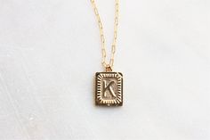 "Trendy and chic this necklace is made for everyday! Wear your favorite letter a rectangle pendant, perfect for a gift too! D E T A I L S -Gold plated rectangle initial pendant -14kt Gold filled shimmering drawn link necklace LENGTH - Please select from the drop down selection. - Choose a 16, 18 or 20 inch inch necklace length. - Standard Length is 18 inches - Pictured at 18\" in photos. C O M P L E T E ∙ T H E ∙ L O O K Styled with: Chunky Link Chain 16\" ∙ EXTRA LOVE ∙ Crafted and curated just 14k Gold Filled Initials Necklace For Everyday, Gold Initial Necklace With Delicate Chain For Personalized Gift, Gold Name Necklace With Initials For Everyday, Everyday Gold Initials Name Necklace, Dainty 14k Gold Filled Initial Necklace Gift, Gold Name Necklace With Initials, Gold Initial Pendant Necklace For Best Friend, Minimalist Initial Pendant Necklace As Best Friend Gift, 14k Gold Filled Initials Charm Necklace For Everyday