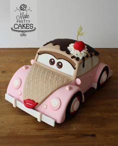 a cake shaped like a car with a cherry on top