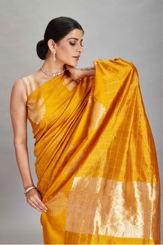 The charm of this yellow silk Banarasi saree is sure to leave everyone awestruck! It is enhanced with zari motifs border and comes with a magenta blouse piece. Disclaimer: The shown stitched blouse on the model is for display purpose only. The saree comes with a matching blouse piece and finished with fall and piko. Disclaimer: The actual product may vary slightly from the image. These are custom orders, hence expect slight variation in color, placement of the motif or buta. ESTIMATED DELIVERYBe Magenta Blouse, Banarasi Sari, Silk Banarasi Saree, Tussar Silk Sarees, Indian Clothing Store, Latest Designer Sarees, Yellow Silk, Tussar Silk Saree, Banarasi Saree