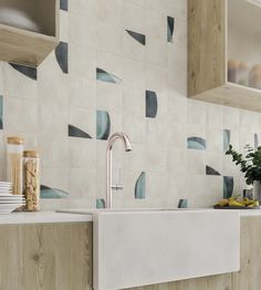 a white sink sitting under a window next to a wooden counter top in a kitchen