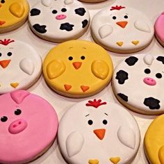 several decorated cookies with farm animals and chickens on them, all in different shapes and sizes