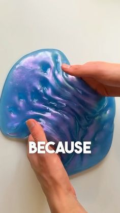 a hand touching a blue object with the words because