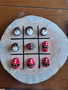 a tic - tac - toe board with snowmen and santa hats on it