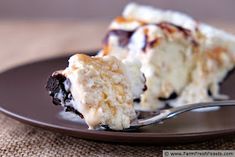 a piece of cake sitting on top of a brown plate with a fork in it