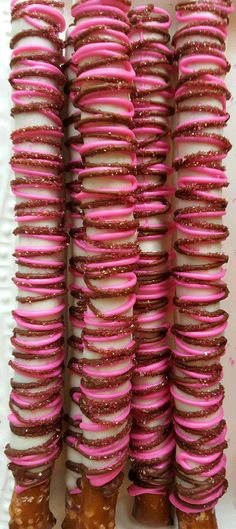 pink and white donuts stacked on top of each other