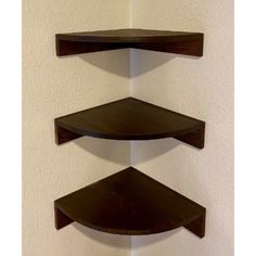 three wooden shelves mounted to the wall