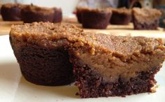 some brownies on a white plate with one cut in half