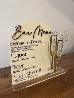 a sign that has some wine glasses on it with the names of different types of drinks