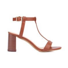 The Livvy sandal showcases the elegance of simplicity with its T-strap design and understated hardware. Emphasizing the "less is more" philosophy, this sandal features a high covered heel that adds a touch of sophistication while maintaining versatility. Perfect for complementing a range of office-appropriate outfits, the Livvy sandal seamlessly transitions from day to evening wear. Its refined design ensures you look polished and professional, making it an essential addition to your work wardro Elegant Adjustable T-strap Sandals With Single Toe Strap, Elegant Adjustable T-strap Sandals With Buckle Closure, Elegant Adjustable T-strap Sandals, Elegant Brown T-strap Sandals With Ankle Strap, Modern T-strap Heels For Summer, Elegant T-strap Sandals With Adjustable Single Toe Strap, Elegant Brown T-strap Sandals With Buckle Closure, Chic Brown Adjustable T-strap Sandals, Elegant Spring T-strap Sandals With Adjustable Strap