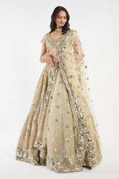 Buy Beige Net V Neck Mirror Embellished Bridal Lehenga Set For Women by Abhinav Mishra Online at Aza Fashions. Anarkali Sets With Gold Mirror Work, Gold Anarkali Set With Mirror Work For Wedding, Gold Anarkali Sets With Mirror Work, Gold Embellished Anarkali Set For Reception, Gold Embellished Kundan Anarkali Set, Festive Anarkali Gold Lehenga, Gold Designer Choli For Diwali, Designer Gold Choli For Diwali, Gold Kundan Choli For Reception