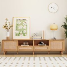 a living room with a flower market poster on the wall next to a wooden entertainment center