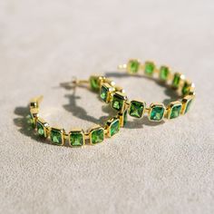 Bring a touch of vibrant elegance to your style with our Gesuina Statement Hoop Earrings. Featuring twelve stunning baguette-cut emerald green cubic zirconia stones, these hoops radiate a captivating sparkle that adds a pop of color and sophistication to any look. Perfect for making a statement at any event or elevating your everyday style, these earrings are destined to become your go-to for unforgettable elegance. Details Medium-weight statement earrings Made of genuine cubic zirconia stone Sk Green Hoop Earrings For Wedding, Elegant Green Hoop Earrings For Wedding, Green Hoop Jewelry For Party, Green Hoop Jewelry For Weddings, Green Hoop Jewelry For Wedding, Elegant Green Hoop Earrings For Formal Occasions, Elegant Jeweled Hoop Earrings Gift, Elegant Green Hoop Earrings For Anniversary, Green Hoop Jewelry For Formal Occasion