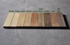 several different colored wood planks laid out on the ground with words written in green