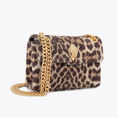 The Mini Leather Kensington is crafted from a leopard printed leather with signature parquet padded overstitch quilting. The brushed gold eagle head sits on the front flap.14cm (H), 20cm (L), 6cm (D)Strap drop cross body: 120cmStrap drop shoulder: 70cmBrushed gold metal chain strap Duo magnetic snap closure hidden under flapBrushed gold metal branded plate on the backCan fit phones up to 7 inchesSmall internal lining pocketOuter: Printed LeatherInterior: Monogrammed interior liningStyle num Luxury Leather Bags In Leopard Print, Luxury Leopard Print Leather Bag, Luxury Leather Shoulder Bag In Leopard Print, Luxury Leather Leopard Print Shoulder Bag, Luxury Leopard Print Rectangular Bag, Luxury Leopard Print Bags For Formal Events, Luxury Leopard Print Shoulder Bag With Gold-tone Hardware, Luxury Tortoiseshell Rectangular Bags, Kurt Geiger Bag