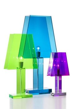 three different colored lamps sitting next to each other