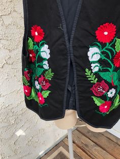 "Vintage Black Denim Vest With Embroidered Flowers Front ties 100% Cotton Beautiful embroidered flowers on front of vest, very vibrant in colour Size Medium Measurements taken while laying flat V Neck Pit to Pit 19\" Sleeve holes 11\" Length from shoulder to bottom 23\" Purchase price includes free shipping in Canada and the USA International shipping is available, please contact before purchase for shipping quote Any questions, just ask! Vintage item, regular wear due to age should be expected Any known flaws/ markings will be listed No returns/ exchanges, but please contact if there is an issue with your item" Folk Style Multicolor Vest For Spring, Multicolor Embroidered Vest For Spring, Embroidered Cotton Vest For Festival, Traditional Cotton Vest For Spring, Cotton Embroidered Vest For Festival, Fall Cotton Embroidered Vest, Fall Embroidered Cotton Vest, Spring Folk Festival Vest, Folk Style Floral Embroidered Vest For Spring