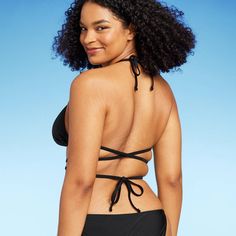 Triangle wrap bikini top from Wild Fable™ in black. Made from soft fabric with 4-way stretch and full lining for flexible comfort in and out of the water. Removable cups offer customizable coverage. Adjustable straps plus back and behind-neck ties provide the perfect stay-put fit. If you're not satisfied with any Target Owned Brand item, return it within one year with a receipt for an exchange or a refund. Wild Fable™: A look for every story. Black Halter Top With Tie Back For Pool, Fitted Triangle Top Swimwear, Versatile Fitted Triangle Top Swimwear, Black Strappy Swimwear With Tie Back, Black Strappy Swimwear With Removable Bra Pads, Full Coverage Black Swimwear With Removable Bra Pads, Versatile 4-way Stretch Swimwear For Beach, Solid Swimwear With Wrap-around Straps For Beach, Versatile Solid Swimwear With 4-way Stretch