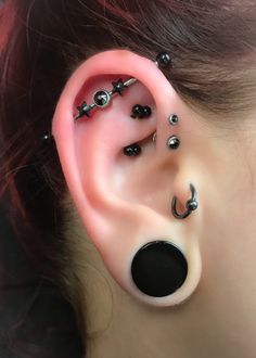 an ear with several piercings attached to it