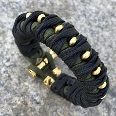 a black and green paracorine bracelet with gold hardwares on it's end