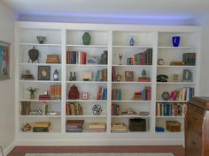 a white book shelf filled with lots of books