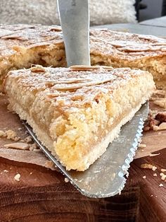 a piece of cake sitting on top of a cutting board with a knife in it