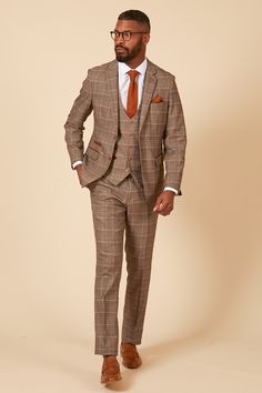 In a subtle light tan with a classic Prince of Wales check, the Ray suit is sophisticated and timeless in its design. Featuring a gold and blue colour pop MD lining and with complimenting brown buttons and velvet trim to the pockets, this three-piece is sure to make an impact at any formal event. The perfect suit for stylish office wear or for attending a wedding. Models wears size 38R blazer, 38R waistcoat & 32R trousers. Features Prince of Wales Check Slim fit Single-breasted Notch lapel Singl Stylish Office Wear, Prince Of Wales Check, Man Office, Check Suit, Checked Suit, Mens Formal Wear, Checked Trousers, A Prince, Stylish Office