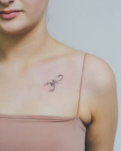 a woman with a small tattoo on her chest