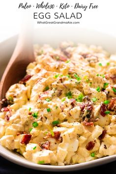 a white bowl filled with egg salad on top of a table