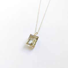 This stunning pendant is set in 14K Solid Yellow Gold with Natural Green Amethyst with utmost precision. It is an unique gemstone pendant for nearly every occasion and is completely hassle-free jewelry. ITEM DETAILS * Gem: Green Amethyst * Gem Size: 10X12mm * Gem Shape: Octagon * Gem Weight: 6.29 carats * Gold Purity: 14KT  * Gold Weight: 0.85 gram * Total Weight of the Pendant: 2.11 gram The Gold purity is guaranteed and it comes with authentic 14KT gold hallmark. Since my items are handmade, they are absolutely nickel and lead free. CUSTOMIZATION * Gemstone customization is available and it can be substituted with a gem of your choice. Kindly message me for the same. PACKAGING * The Pendant comes with layers of safe and secure wrapping along with Free handmade jewelry box with every purc Handmade Jewelry Box, Amethyst Gem, Bezel Pendant, Birthstone Pendant, February Birthstone, Amethyst Pendant, Unique Gemstones, Pendant Gold, Green Amethyst