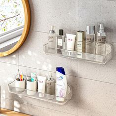 two clear shelfs holding personal care items in front of a mirror on the wall