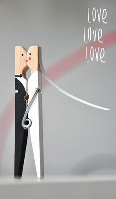 a pair of scissors cutting into a piece of paper with the words love love on it