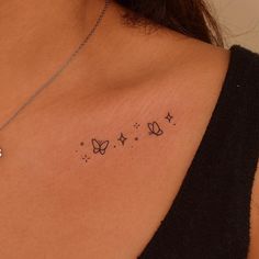 a woman's chest with butterflies and stars on the left side of her stomach