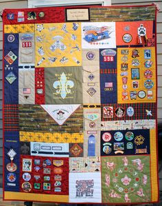 a quilt made to look like it has many different patches and badges on it's side