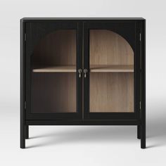 a black and wood cabinet with glass doors