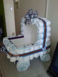 a large mirror made out of diapers with a bow on the front and side