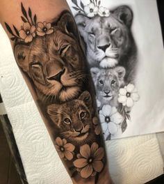 a lion and two cubs with flowers on their arm