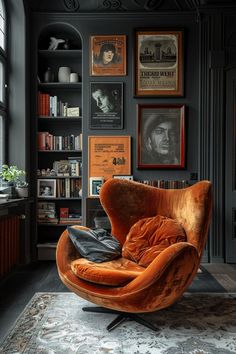 an orange chair sitting on top of a rug in front of a book shelf filled with books