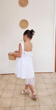 "Sweet and simple dress that is perfect for your flower girls. Featuring a long soft tulle strap at the back that you tie in a bow and gives a sweet classy vibe. The back waist elastic offers a room for growth and for perfect fit. Fully lined bodice and skirt for comfort. The dress is made with 100% natural cotton fabric ( exept of the strap which is made of soft tulle). For jumpsuit version for this dress ❤️ : https://www.etsy.com/listing/1383089335/flower-girl-jumpsuit-flower-girl-dress?click_ Preppy Family, Boho Flower Girl Dress, Boho Flower Girl, Dress Minimalist, Wedding Flower Girl Dresses, Cute Headbands, Minimalist Dresses, Simple Dress, Wedding Flower Girl