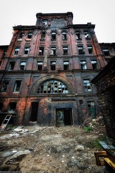 an old building with lots of windows and broken doors