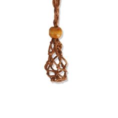 a wooden bead hanging from a rope on a white background with an orange stone in the center