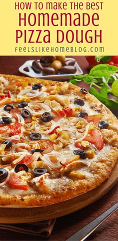 a homemade pizza with olives, tomatoes and other toppings on a cutting board